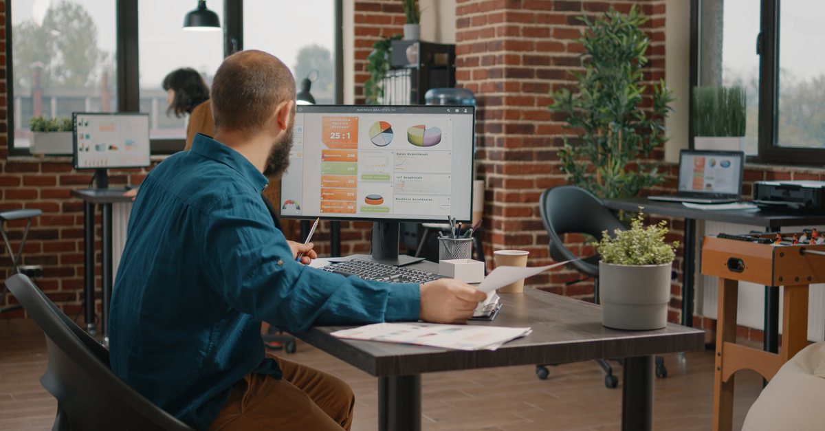 Marketer reviewing analytics charts on a computer monitor